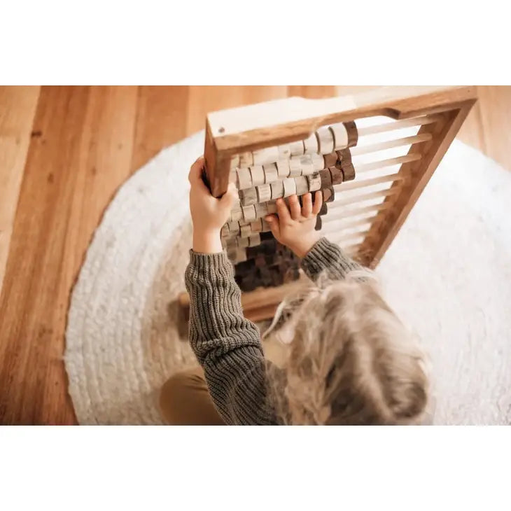 Child playing with wooden abacus toy