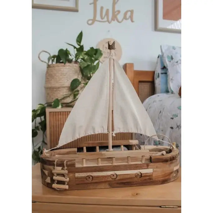 Wooden toy sailboat in child's bedroom