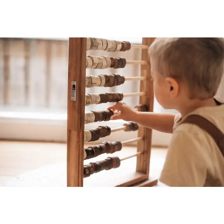 Child playing with wooden abacus toy