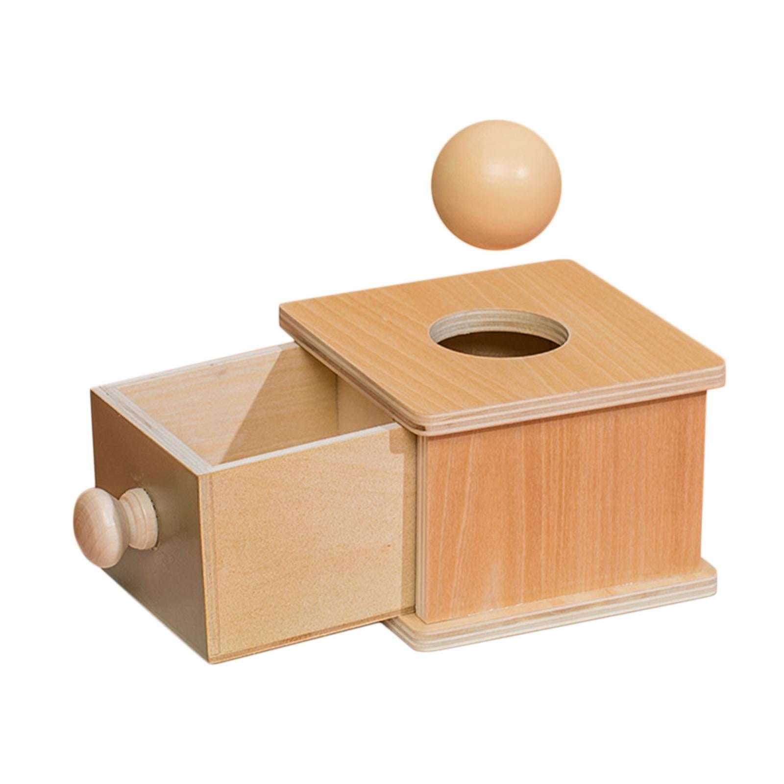 Wooden object permanence box, drawer open with ball hovering above