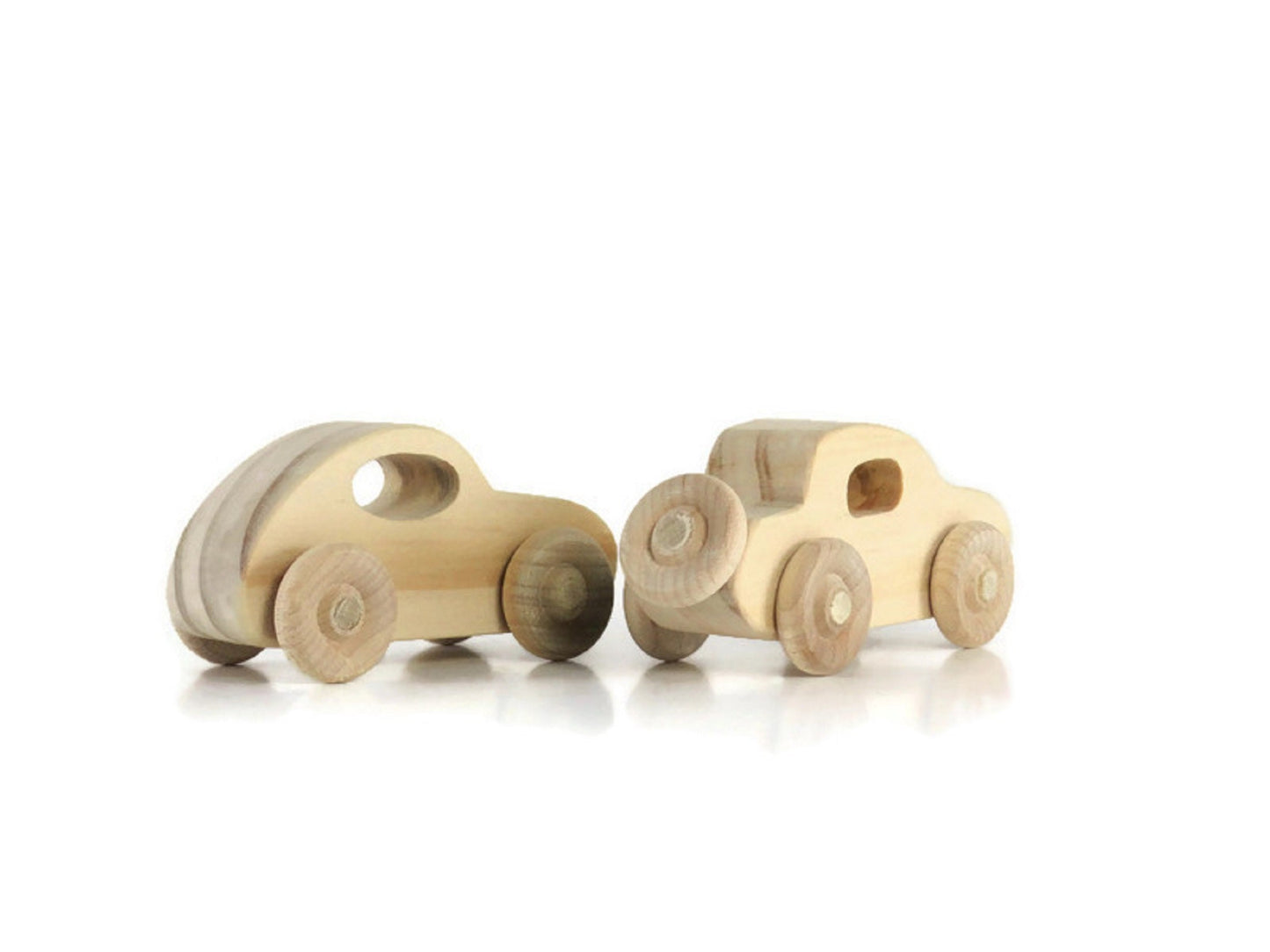 Two small wooden toy cars